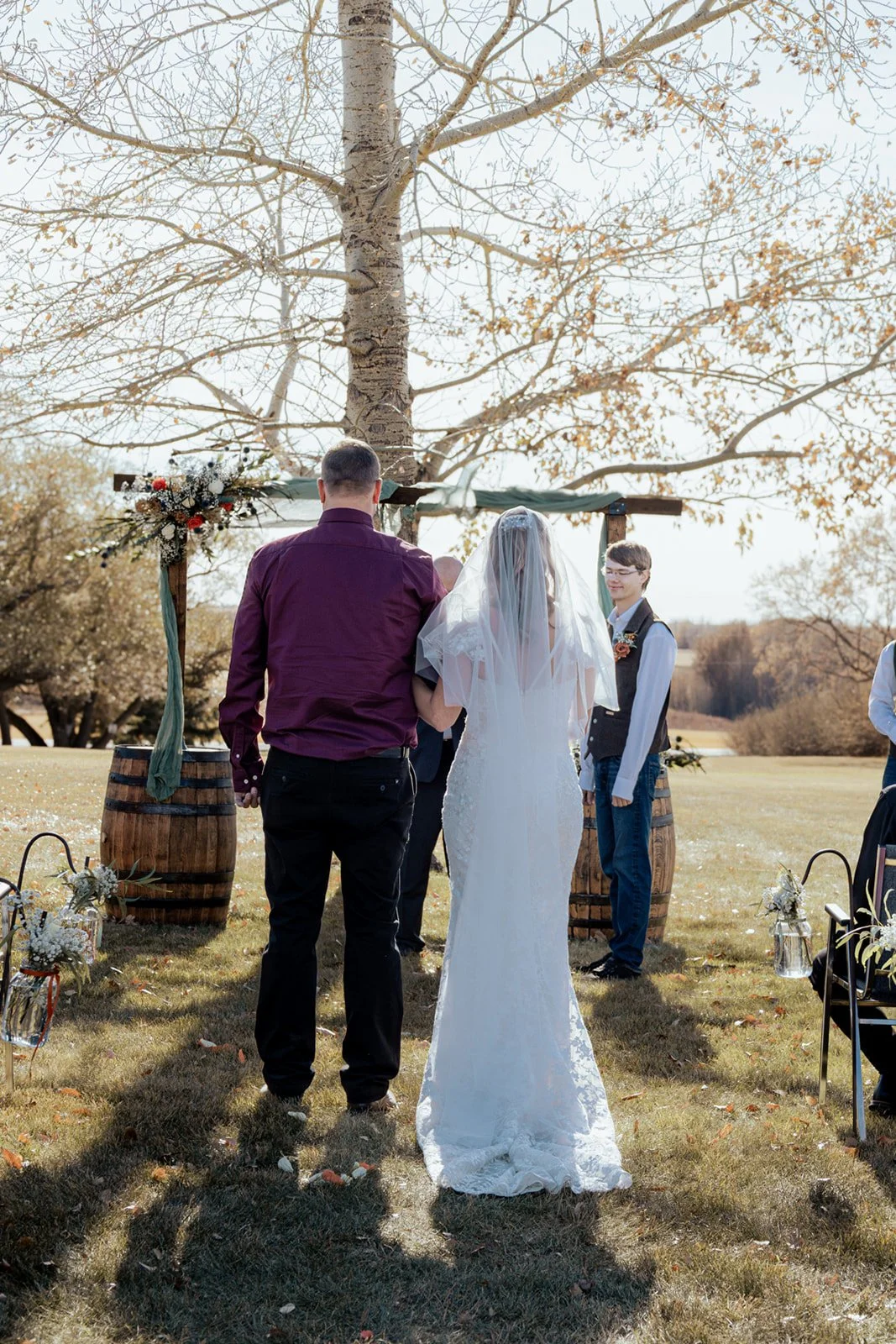 Father walking daughter down the aisle at a gorgeous autumn wedding photography in the Alberta Prairies, only 70 minutes away from Calgary Alberta at Open Country Farm event centre and cabin retreats