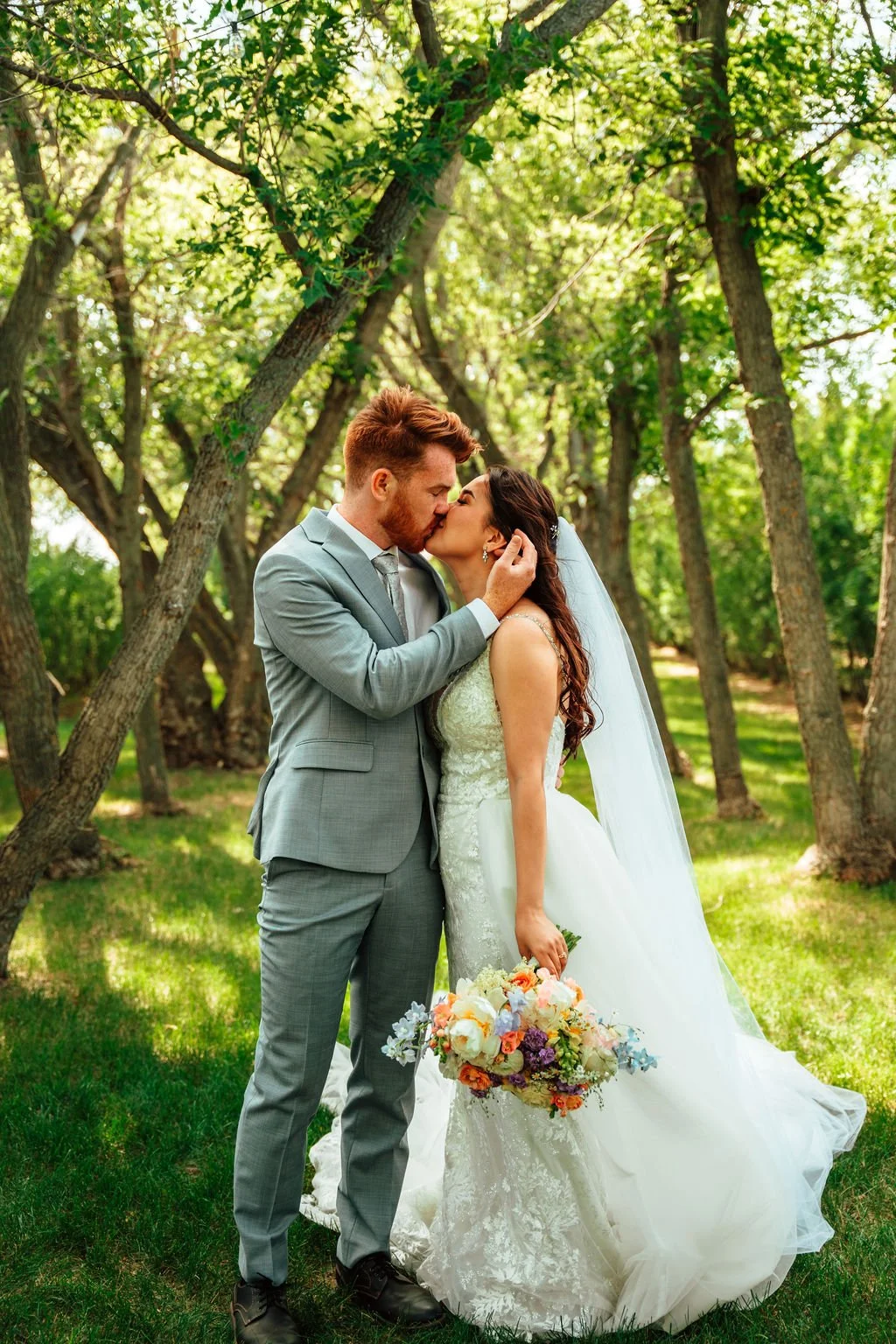 Couple exchanging vows at outdoor prairie wedding in The Grove at Open Country Farm, Three Hills, Alberta