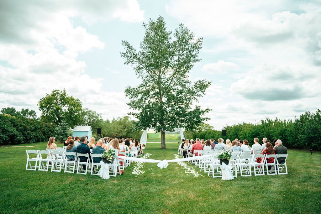 Outdoor Wedding Ceremony at Open Country Farm prairie venue near Calgary, Alberta with guests seated under open sky