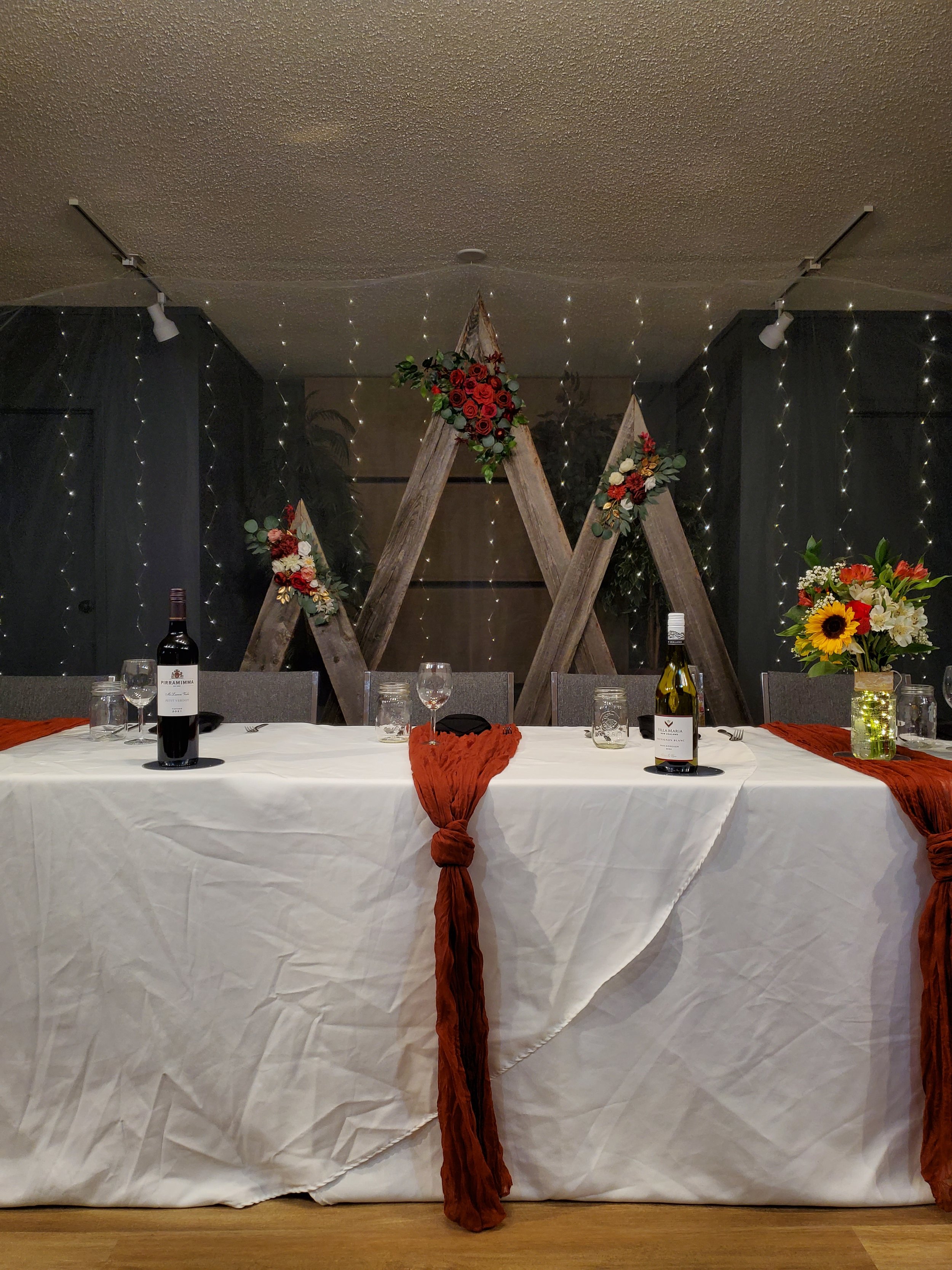 Head table and backdrop design at a wedding reception in the wedding venue Open Country Farm near Three Hills Alberta