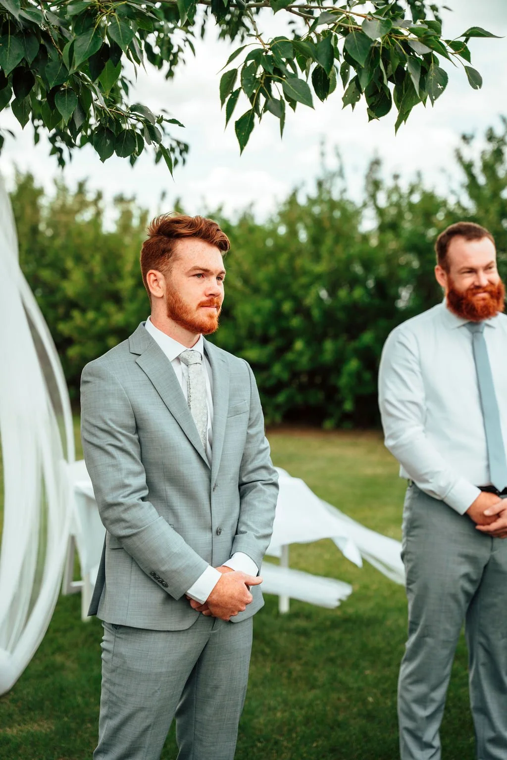 Groom and groomsmen photography outside in lush green Alberta wedding destination, Open Country Farm, near Red Deer