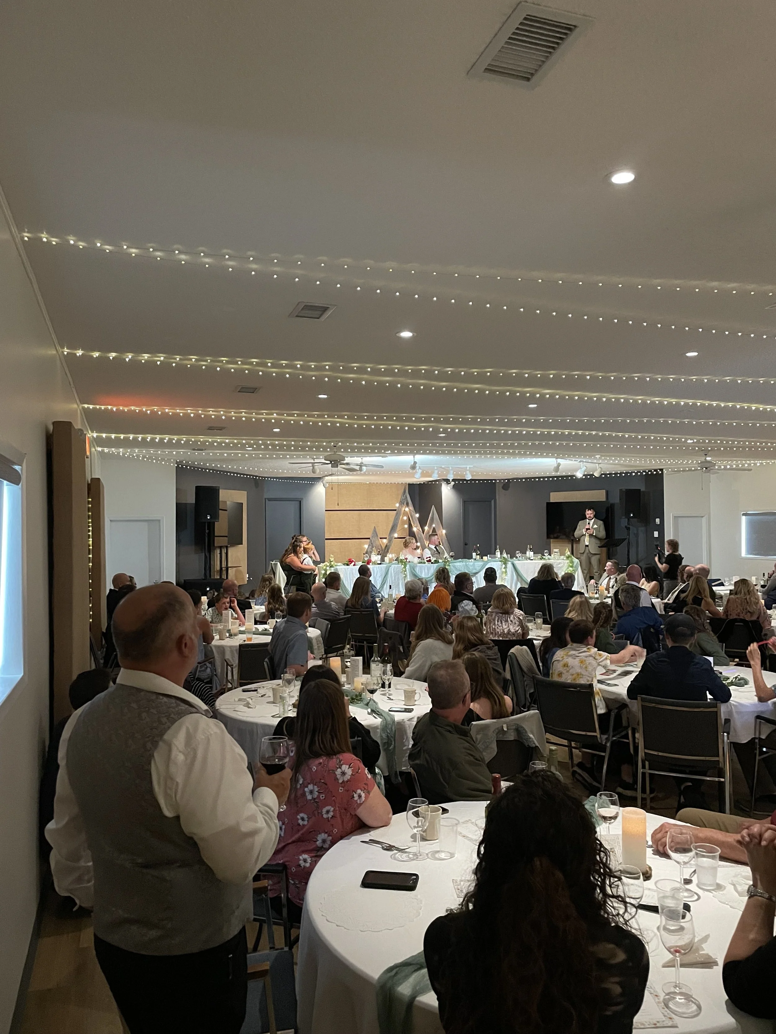 Reception at Central Alberta Event Centre, a full room of 120 guests enjoying a wedding at Open Country Farm Wedding Venue, a hidden gem found near Red Deer Alberta
