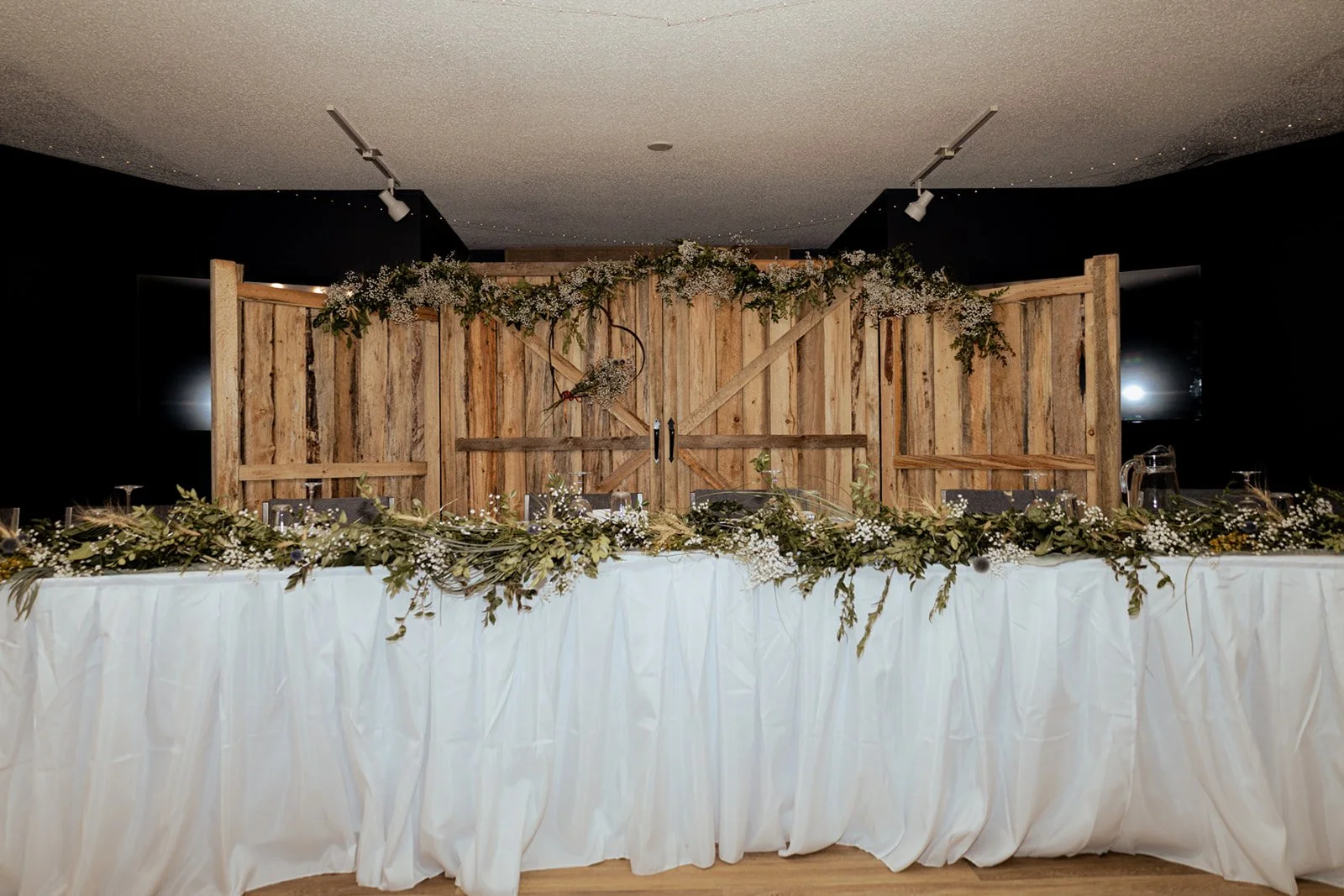 Wedding reception backdrop inside the auditorium space at Open County Farm wedding venue a top rural wedding destination near Linden Alberta