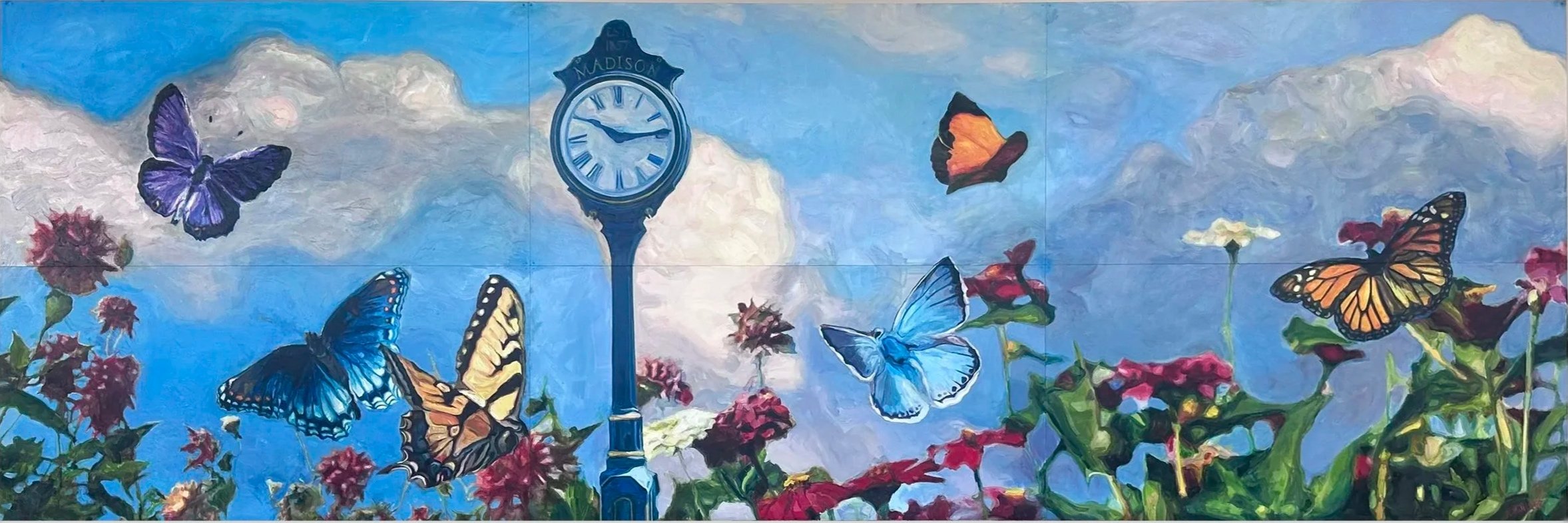 A mural featuring a blue sky with clouds, colorful butterflies, red and pink flowers, and a street clock with 'Madison' written on it.