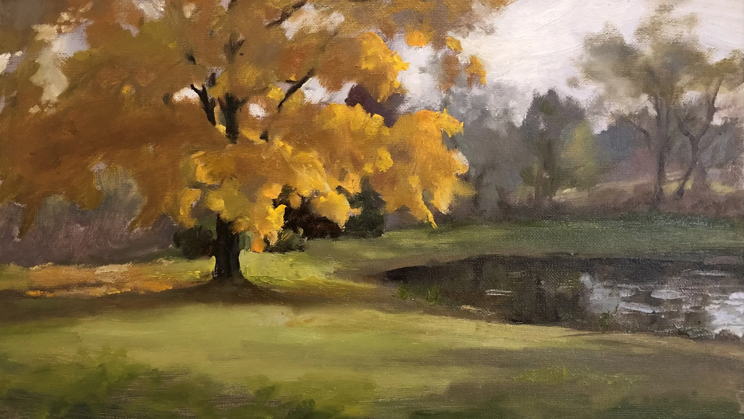 Oil painting of a fall landscape with a large tree with orange and yellow leaves near a small stream, background includes more trees with sparse foliage under a cloudy sky.