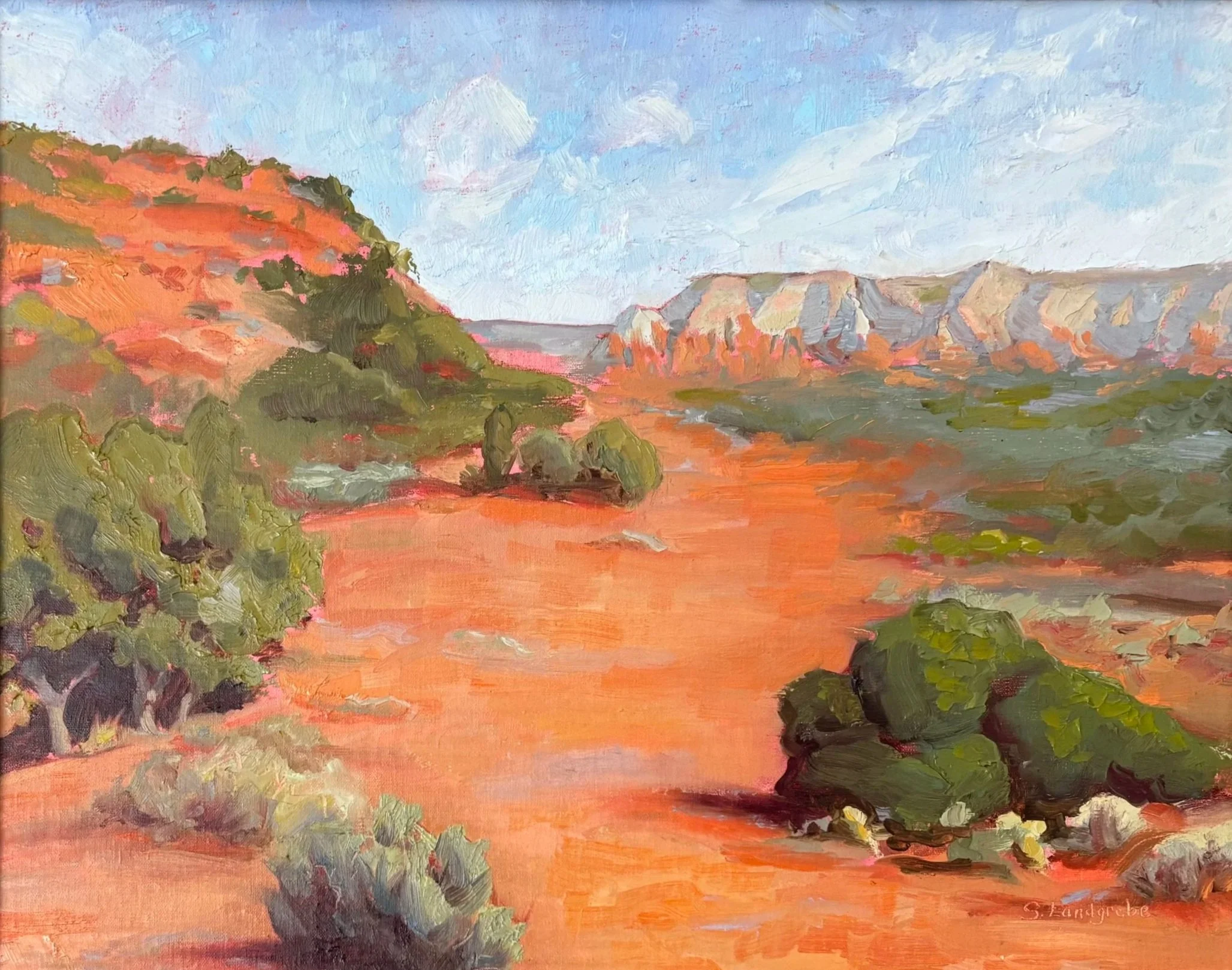 A landscape painting of a desert with red-brown terrain, green bushes, distant cliffs, and a blue sky with clouds.