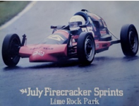 A vintage race car on a wet track during a July Firecracker Sprint event at Lime Rock Park.