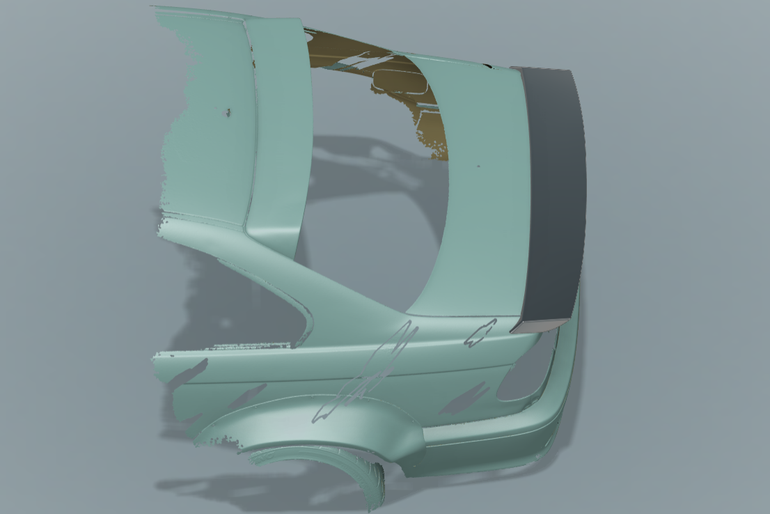 Automotive scan-to-CAD workflow: High-precision 3D scan of a vehicle rear end with a custom-designed spoiler perfectly aligned to the scan data.