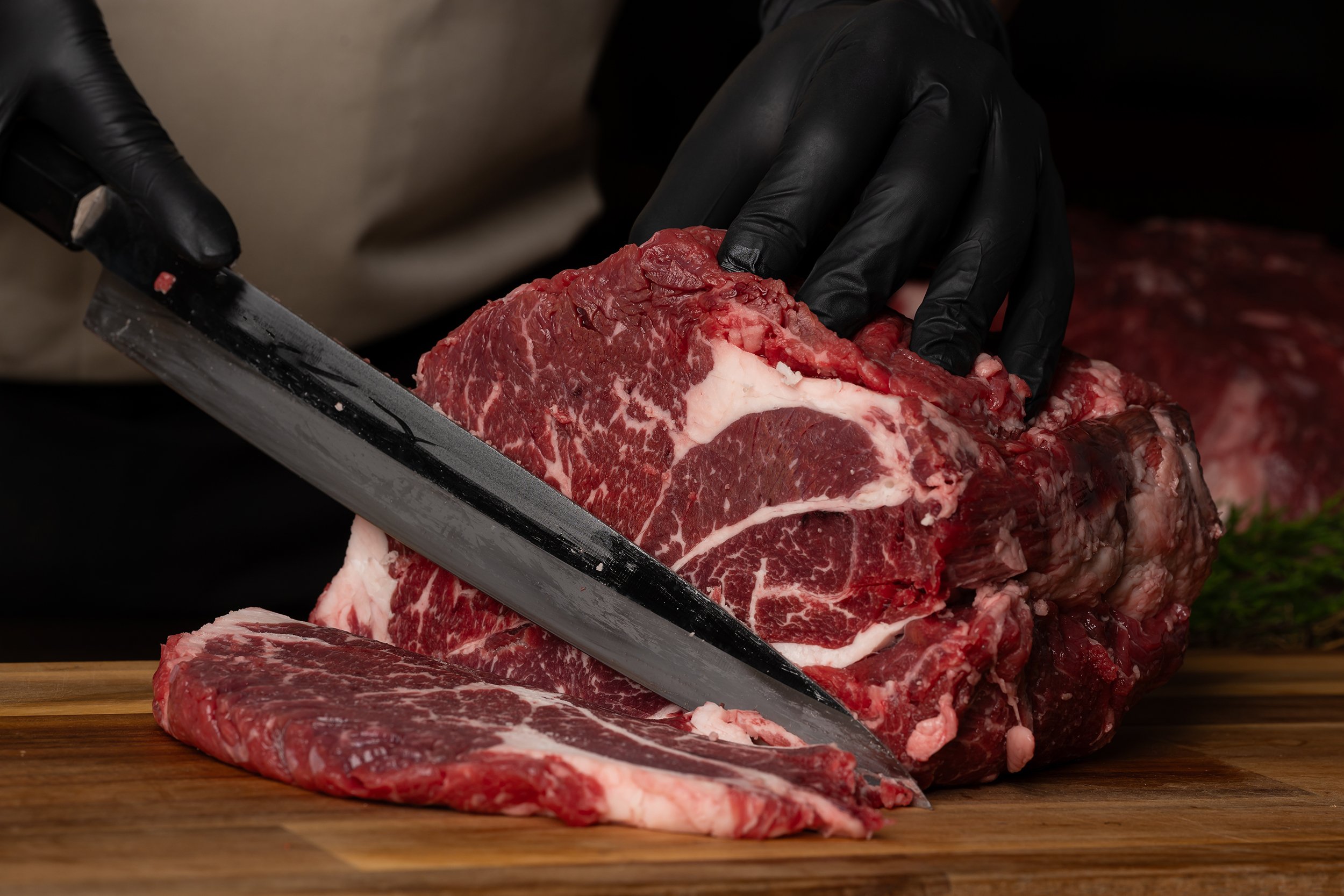 Master butcher slicing ribeye steak - Quality meats at Dickenson's of Fulham