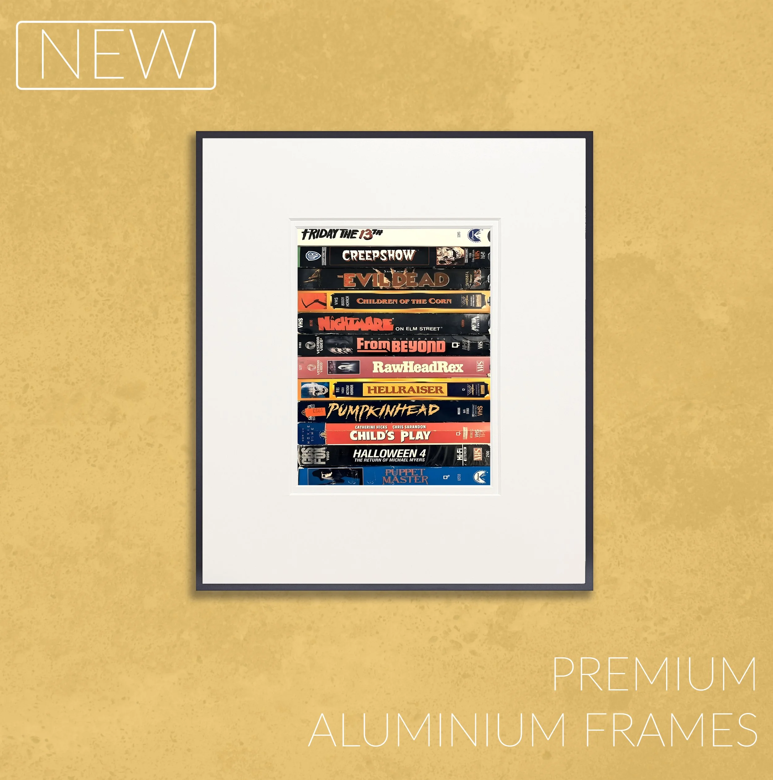 A framed collection of horror movie DVDs on a yellow textured wall, labeled as premium aluminum frames, with a "NEW" tag in the top left corner.