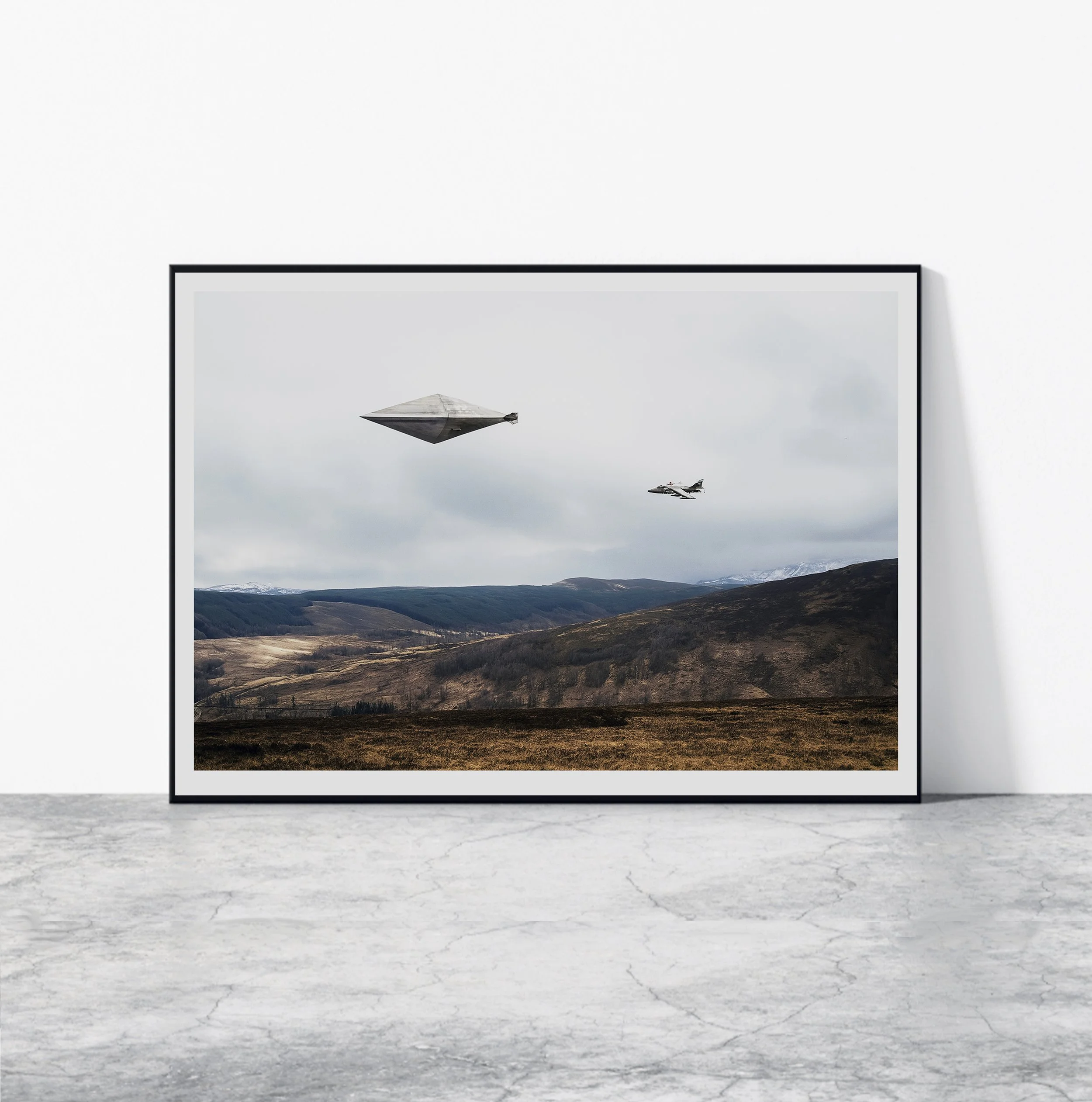 Artwork depicting a landscape with mountains and clouds, featuring a spaceship and a jet flying in the sky.