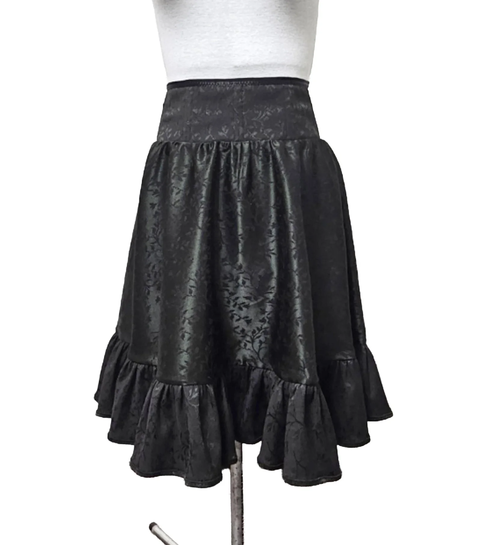 Dark green satin jacquard midi skirt with a black ruffled hem and black corset waist, displayed on a mannequin. One of a kind and vintage inspired design.