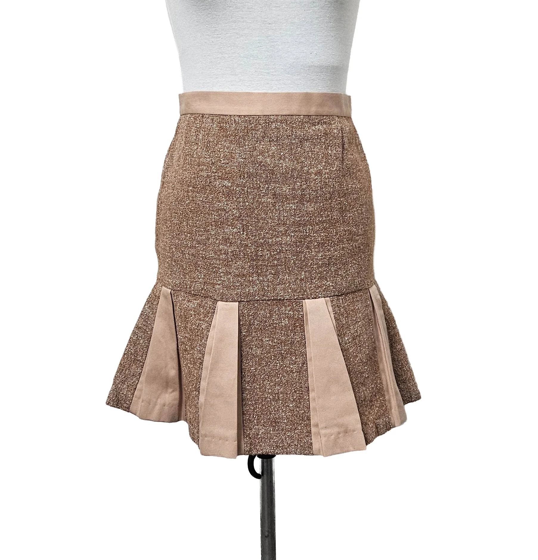 A retro brown and pink fit and flare midi skirt, with pleats and a wide waistband displayed on a mannequin.