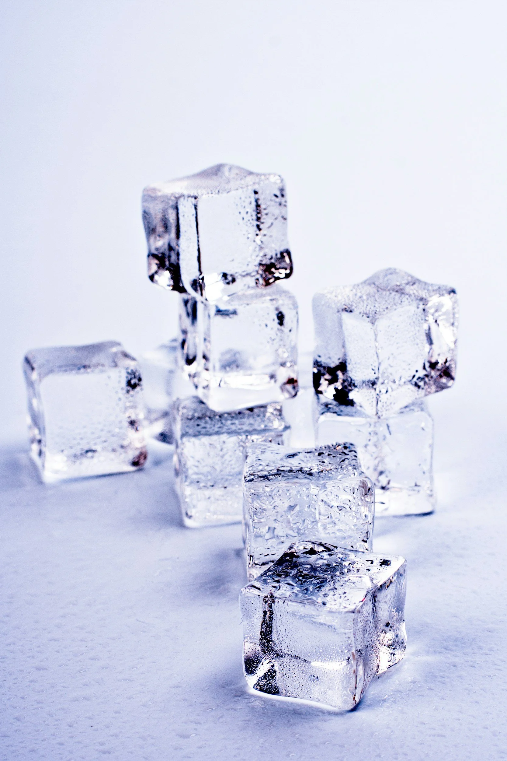 A person holding an ice cube in their palm as a grounding technique for financial panic and anxiety.| Systemic Exhaustion Landlocked by Insurance Navigational Burnout The "Shadow" of Debt Administrative Burden