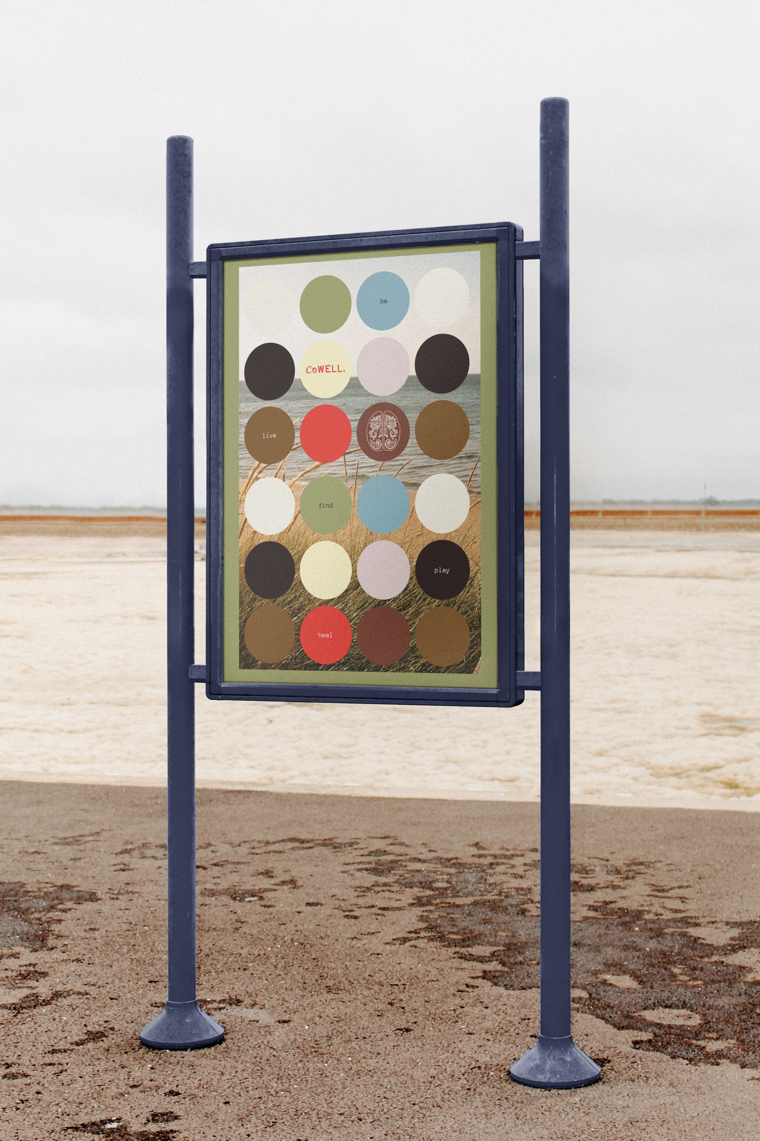 A tall blue-metal signage is at the beach. The signage shows a poster design that features beach imagery placed behind a collection of multicoloured circles. Collectively, the circles have CoWell branding and say "be, live, find, play, heal".