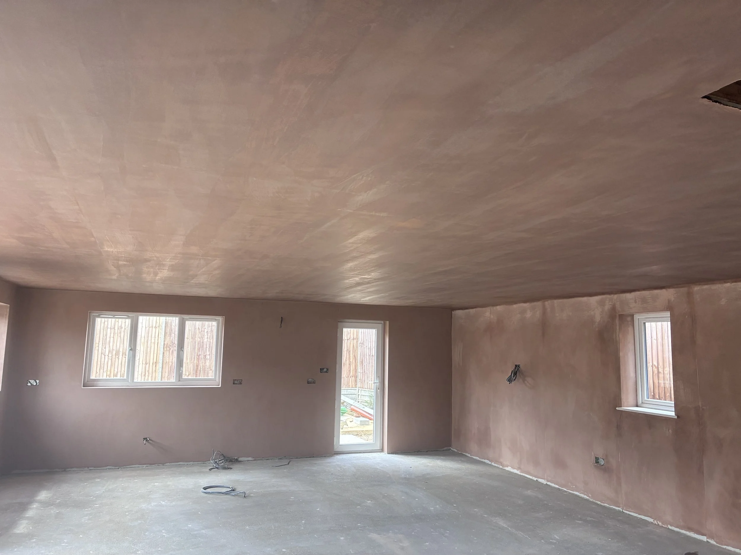 Freshly skimmed living room with smooth plastered walls and ceiling following a bungalow renovation in St Neots.
