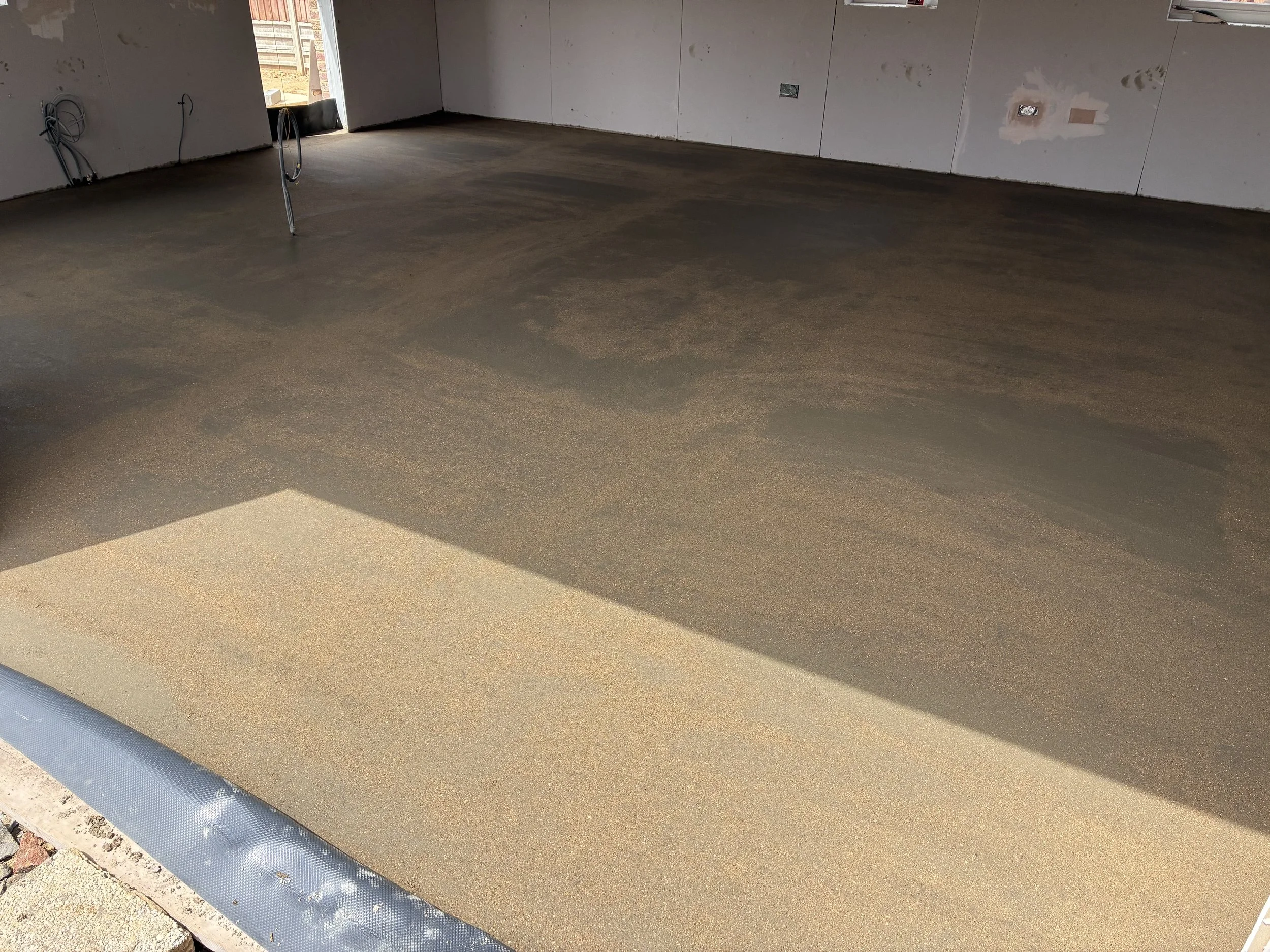 Completed sand and cement floor screed providing a smooth, level surface ready for final floor coverings in a St Neots bungalow.