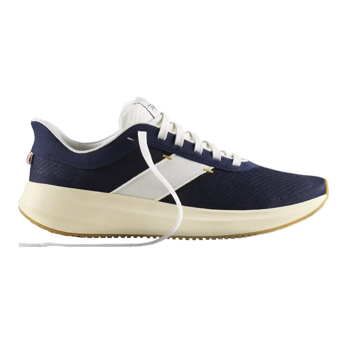 Navy and white athletic sneaker with a cream-colored sole and white laces. Tracksmith.