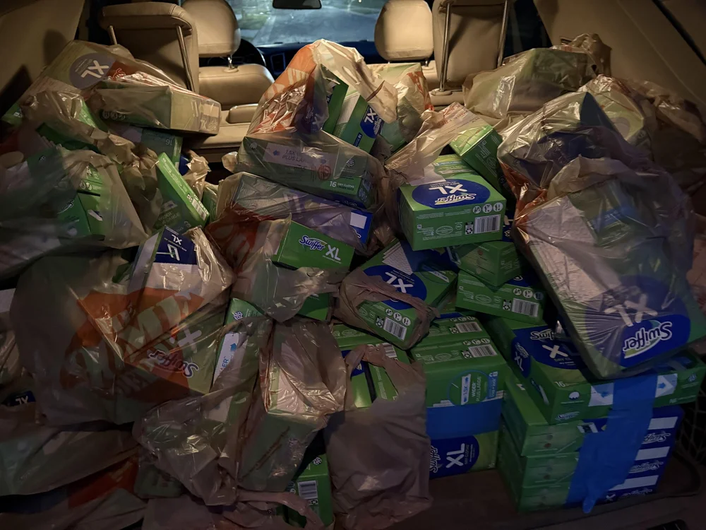 Boxes of brand-name cleaning refills loaded in a vehicle, ready to list