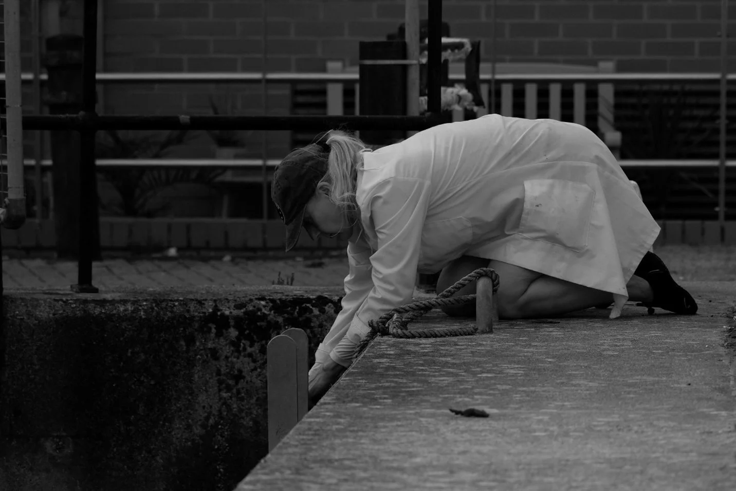 A lady fishes for crabs in a Portsmouth harbour