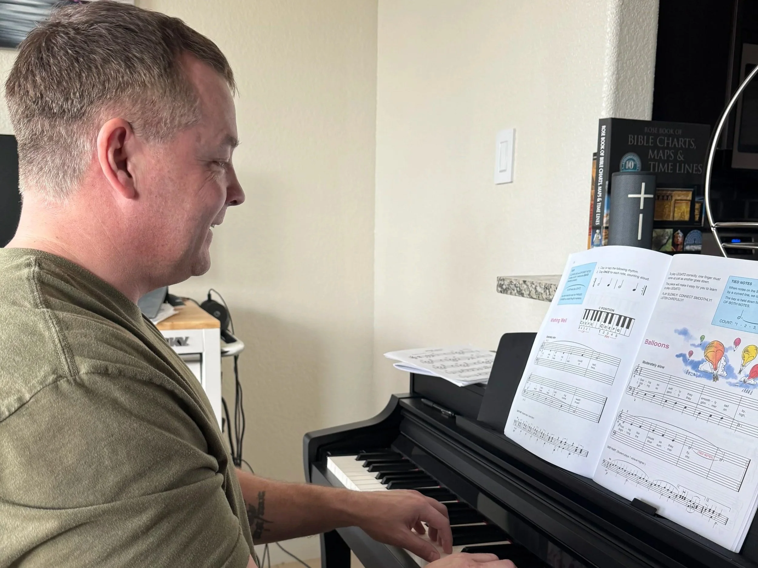 Man sits at piano at home and plays