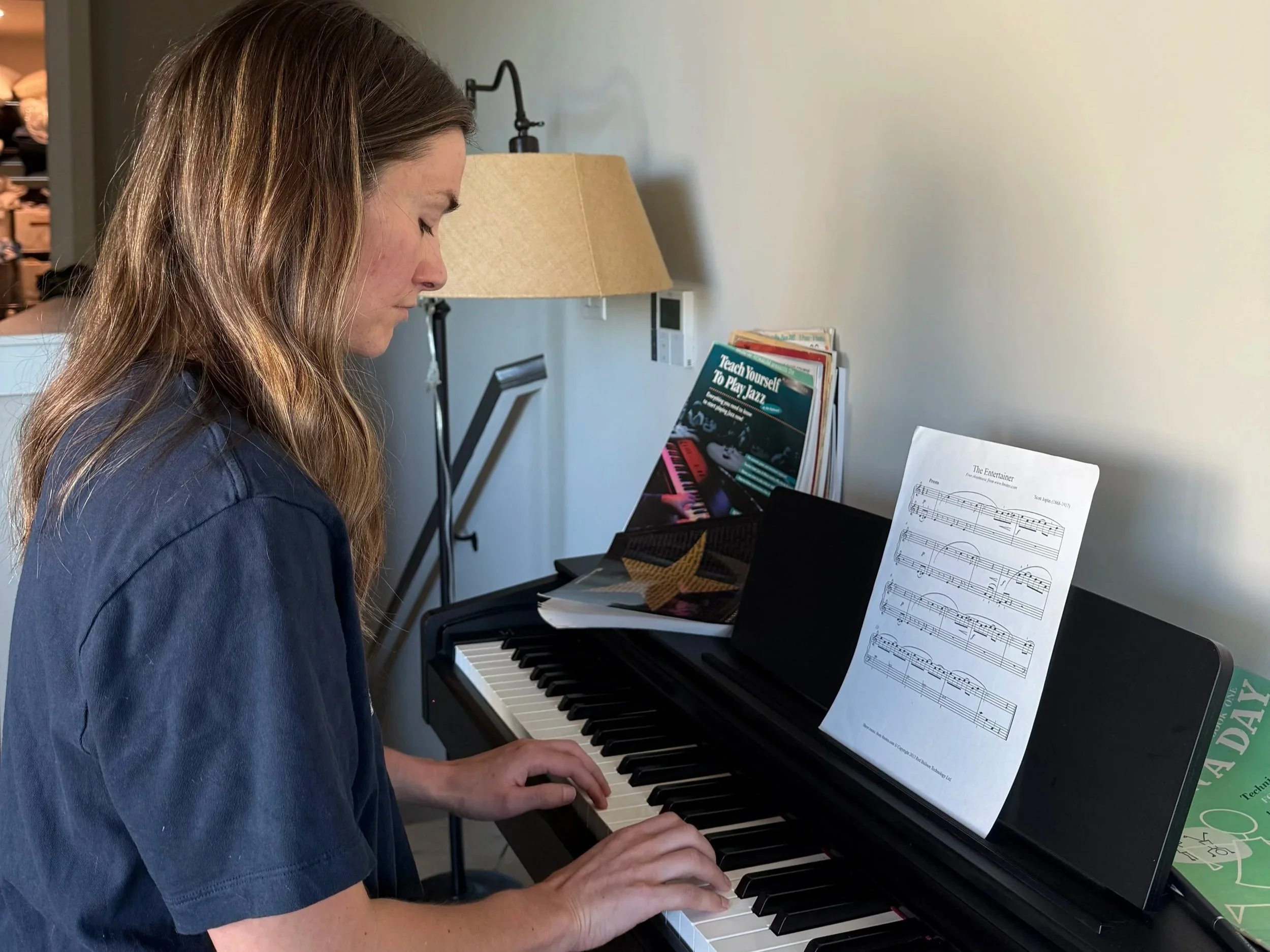 Woman playing piano at home.