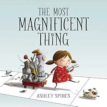 Book cover titled 'The Most Magnificent Thing' by Ashley Spires, featuring a girl in a red dress pulling a cart with a robot and a small dog walking ahead.
