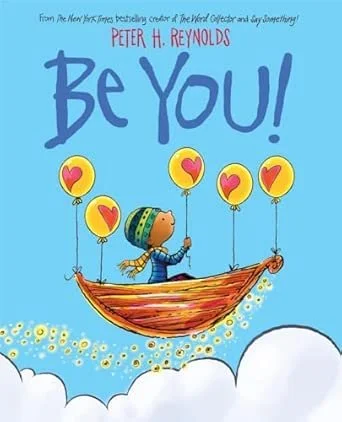 Children's book cover titled 'Be You!' by Peter H. Reynolds. Illustration of a child in a boat floating among clouds, holding balloons with hearts.