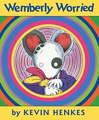 Book cover titled "Wembley Worried" by Kevin Henkes featuring a cartoon mouse with large ears, one eye, holding a yellow object, surrounded by concentric circles of bright colors.