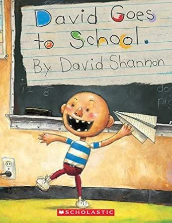 Children's book cover titled 'David Goes to School' by David Shannon, featuring a happy cartoon boy with a round face, big smile showing teeth, and a blue and white striped shirt, holding paper airplanes in a classroom setting.