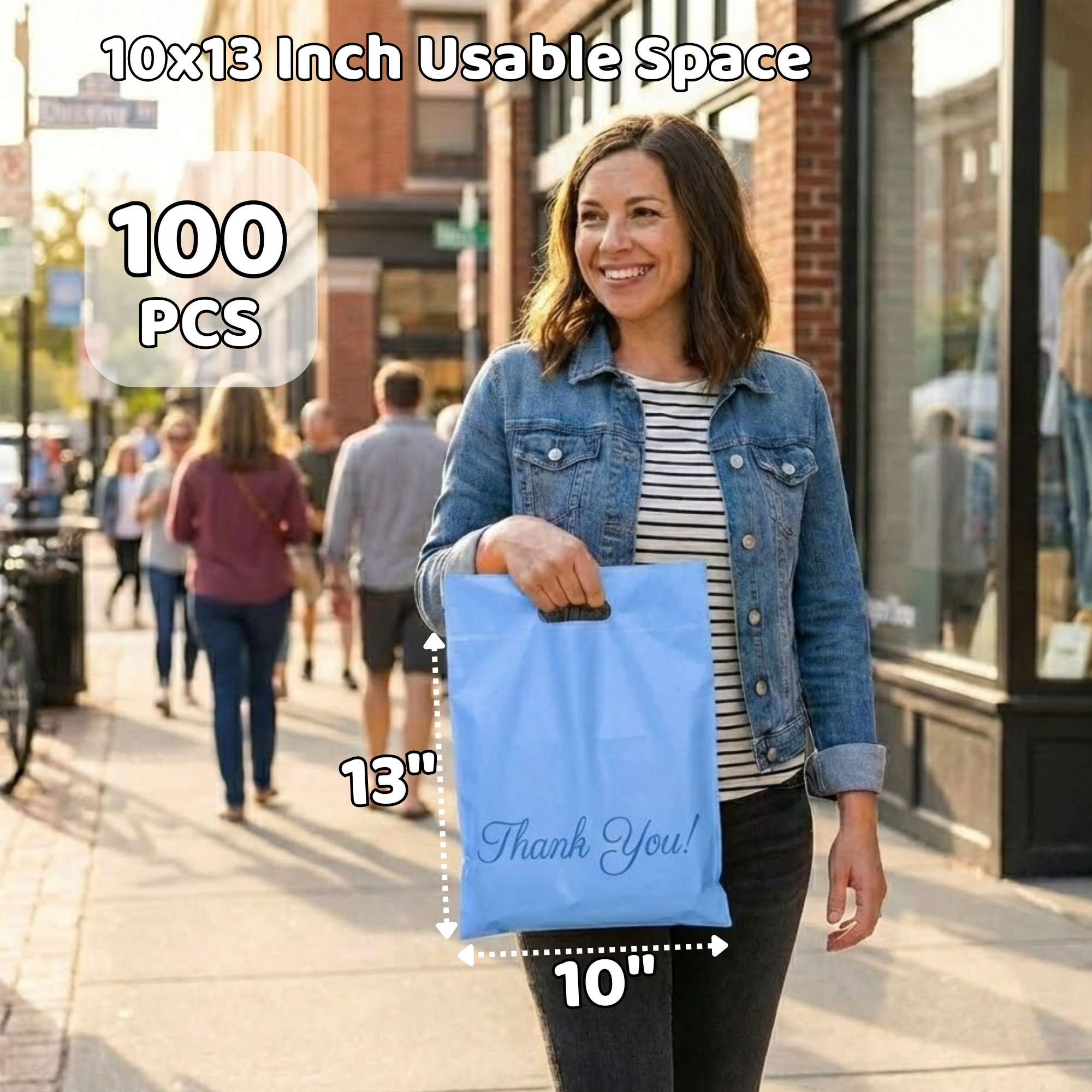 Woman walking on sidewalk holding a light blue paper bag with 'Thank You!' written on it, wearing a denim jacket and striped shirt, in a city with other pedestrians and brick buildings.