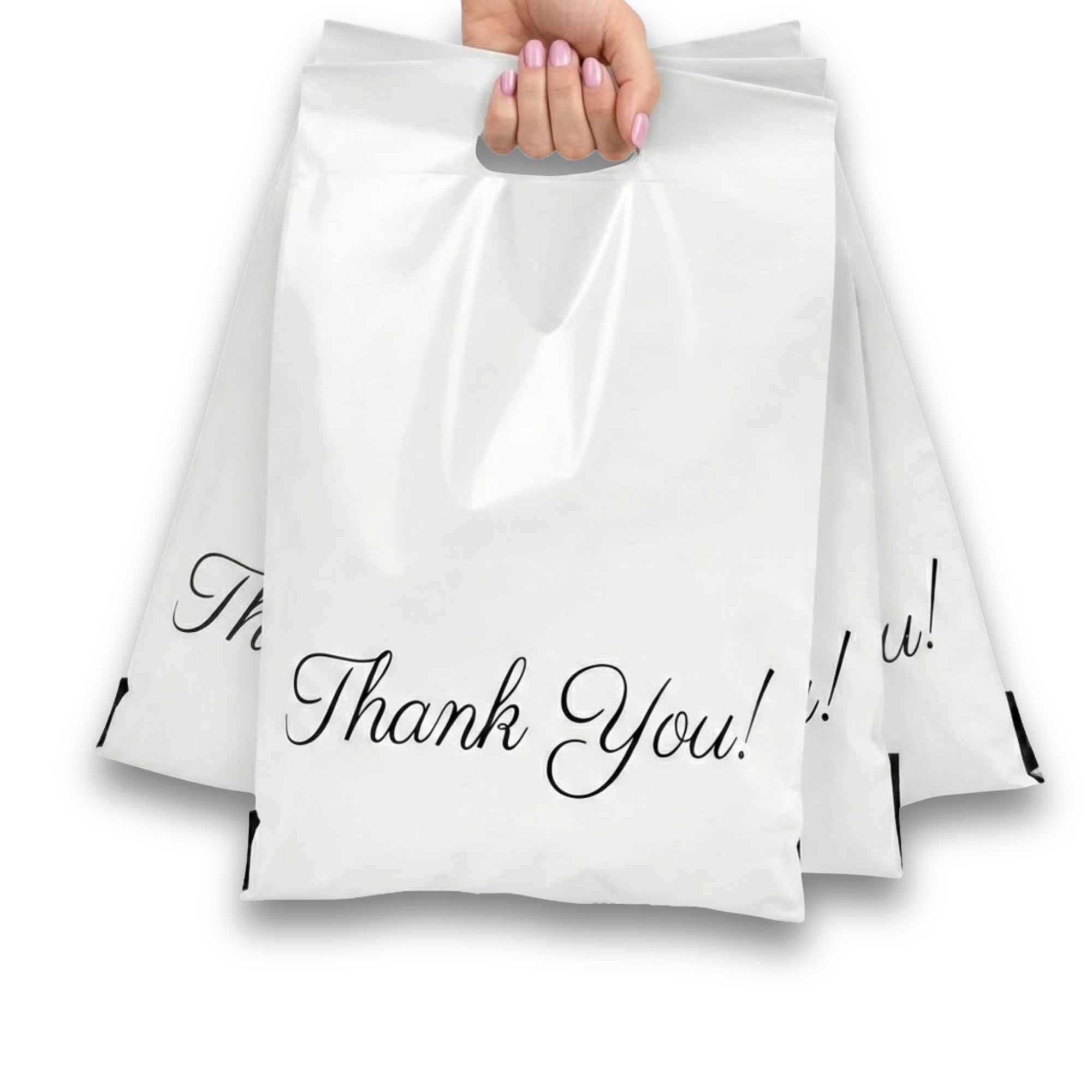 Hand holding a white paper bag with 'Thank You!' written on it, with two more similar bags behind it.