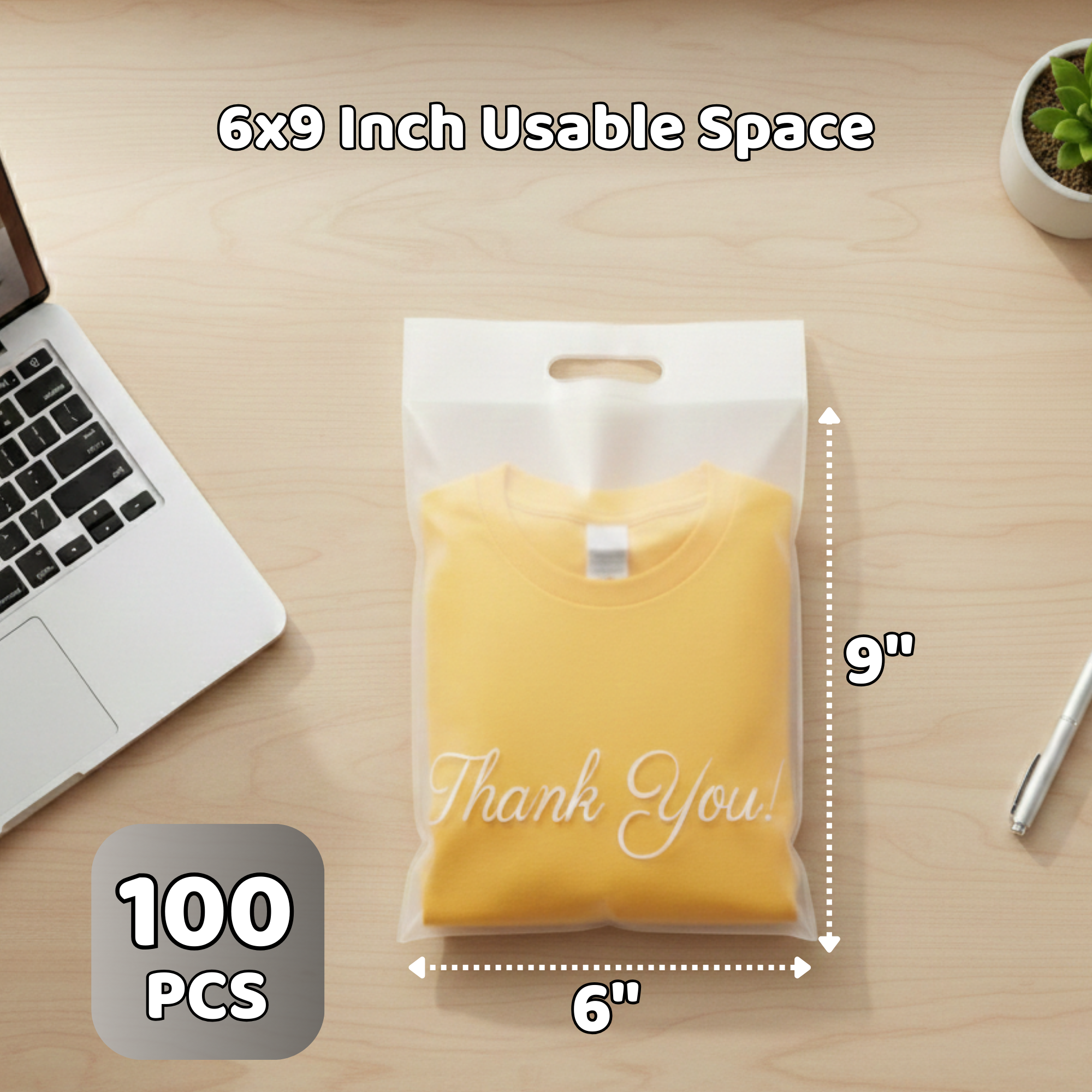 A pack of 100 yellow thank you cards in a clear plastic bag, measuring 6 inches wide and 9 inches tall, placed on a wooden desk with a laptop keyboard on the left, a small potted plant on the top right, and a white pen on the right.