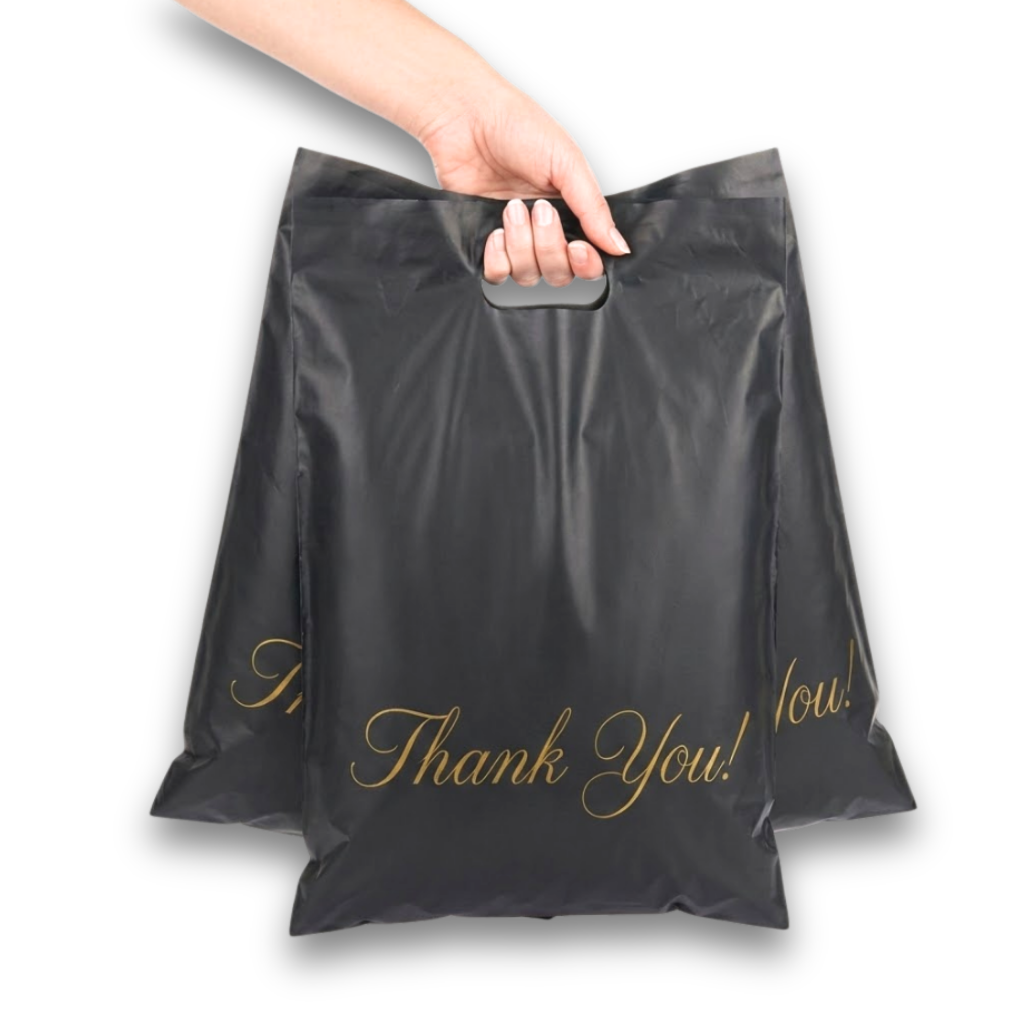 Hand holding black shopping bags with gold 'Thank You!' lettering.