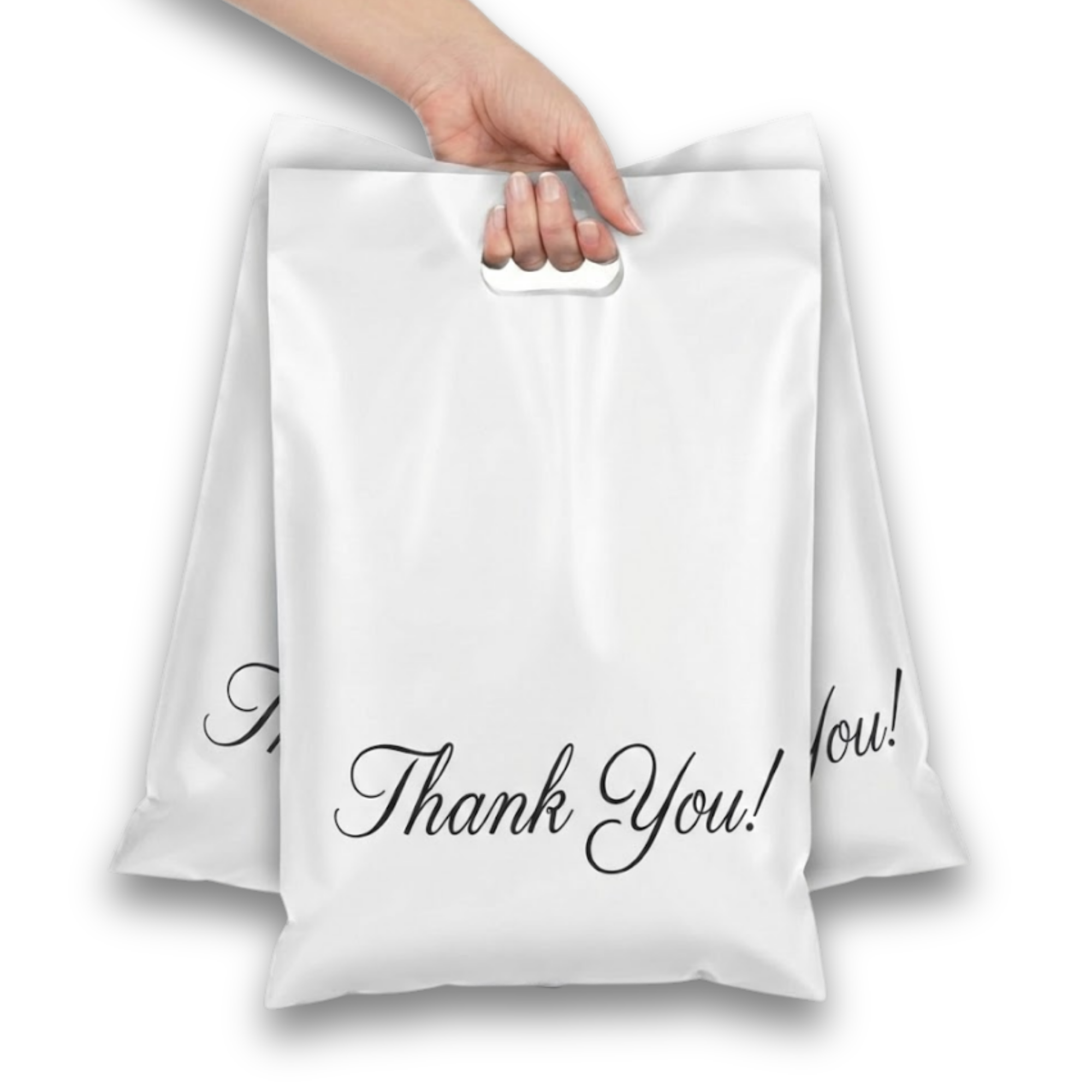 Two white gift bags with black cursive text saying "Thank You!", one hand holding the handle of the front bag.