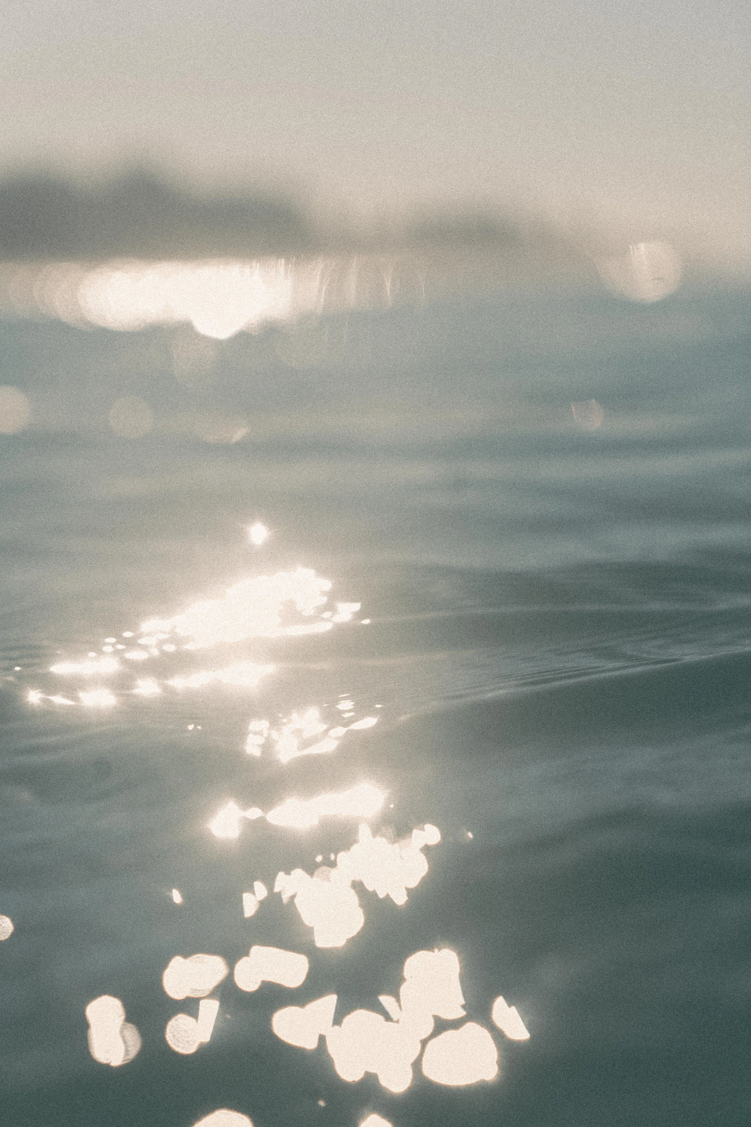 Sunlight reflecting off the water surface creating bright spots and ripples.