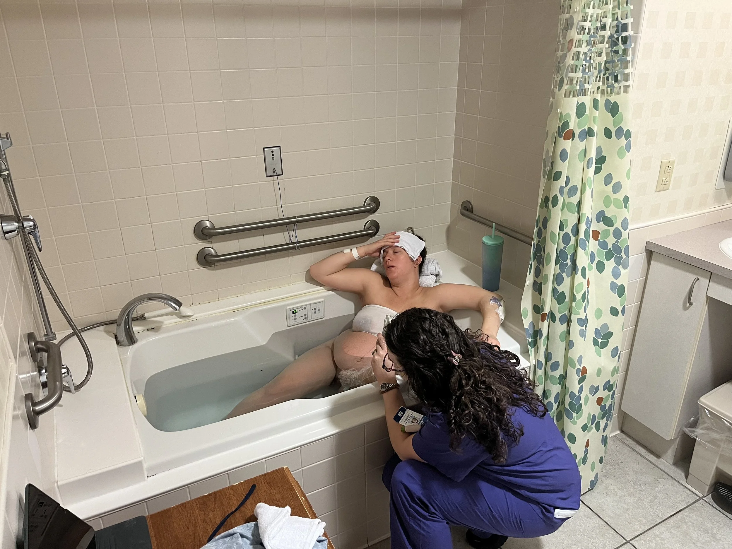 Woman laboring in a tub using hypnobirthing techniques