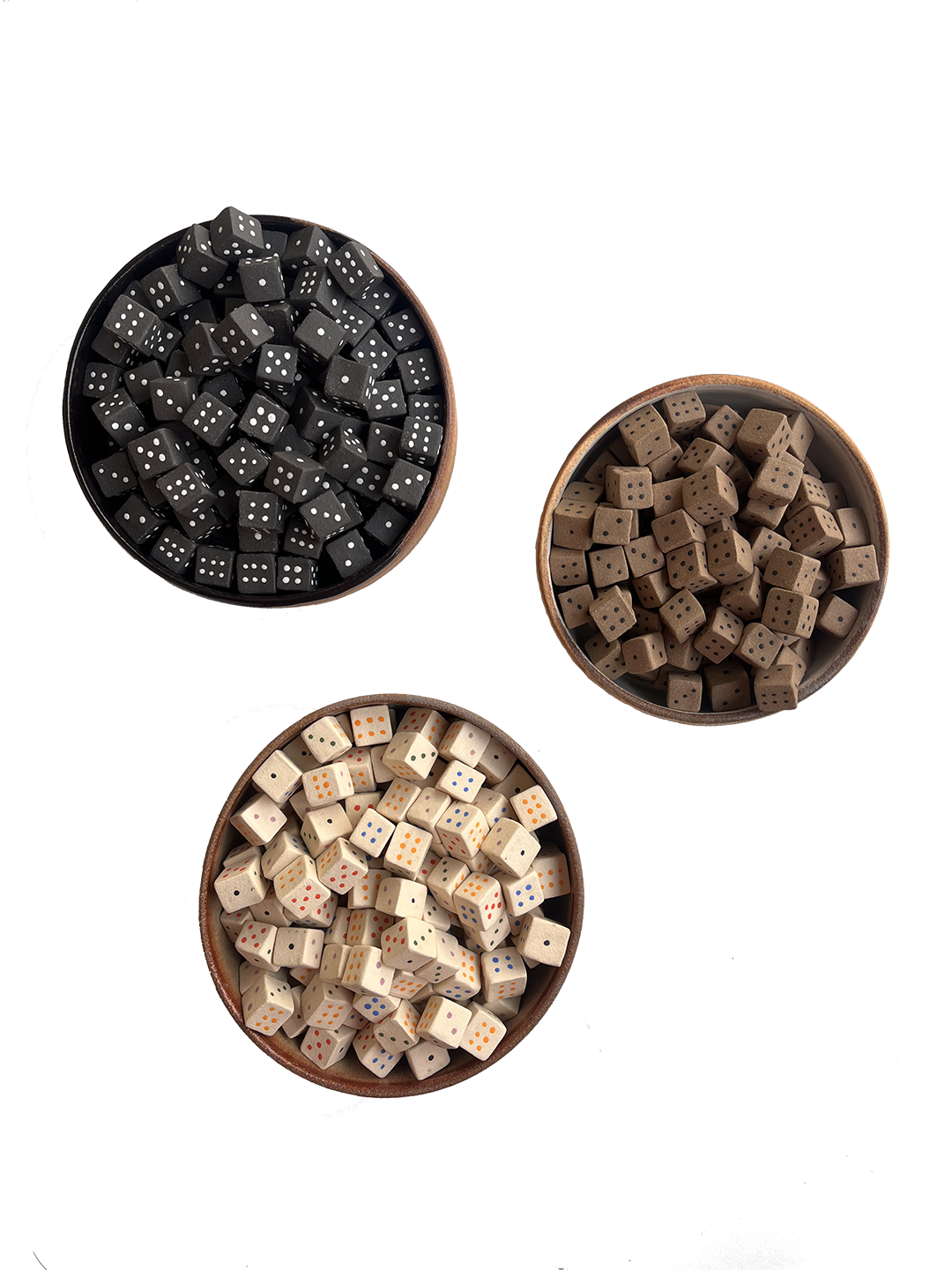 Three bowls of dice with different colors and patterns: black with white dots, brown with black dots, and beige with multicolored dots.