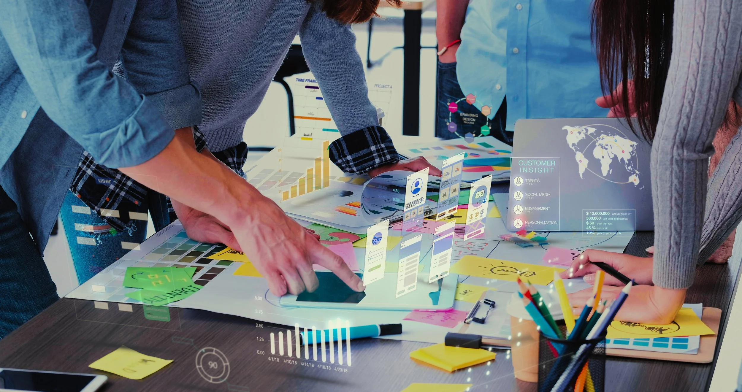 People collaborating around digital data and strategy planning in a modern workspace.
