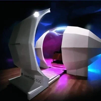 Futuristic medical imaging device resembling an egg-shaped scanner with colorful lighting.