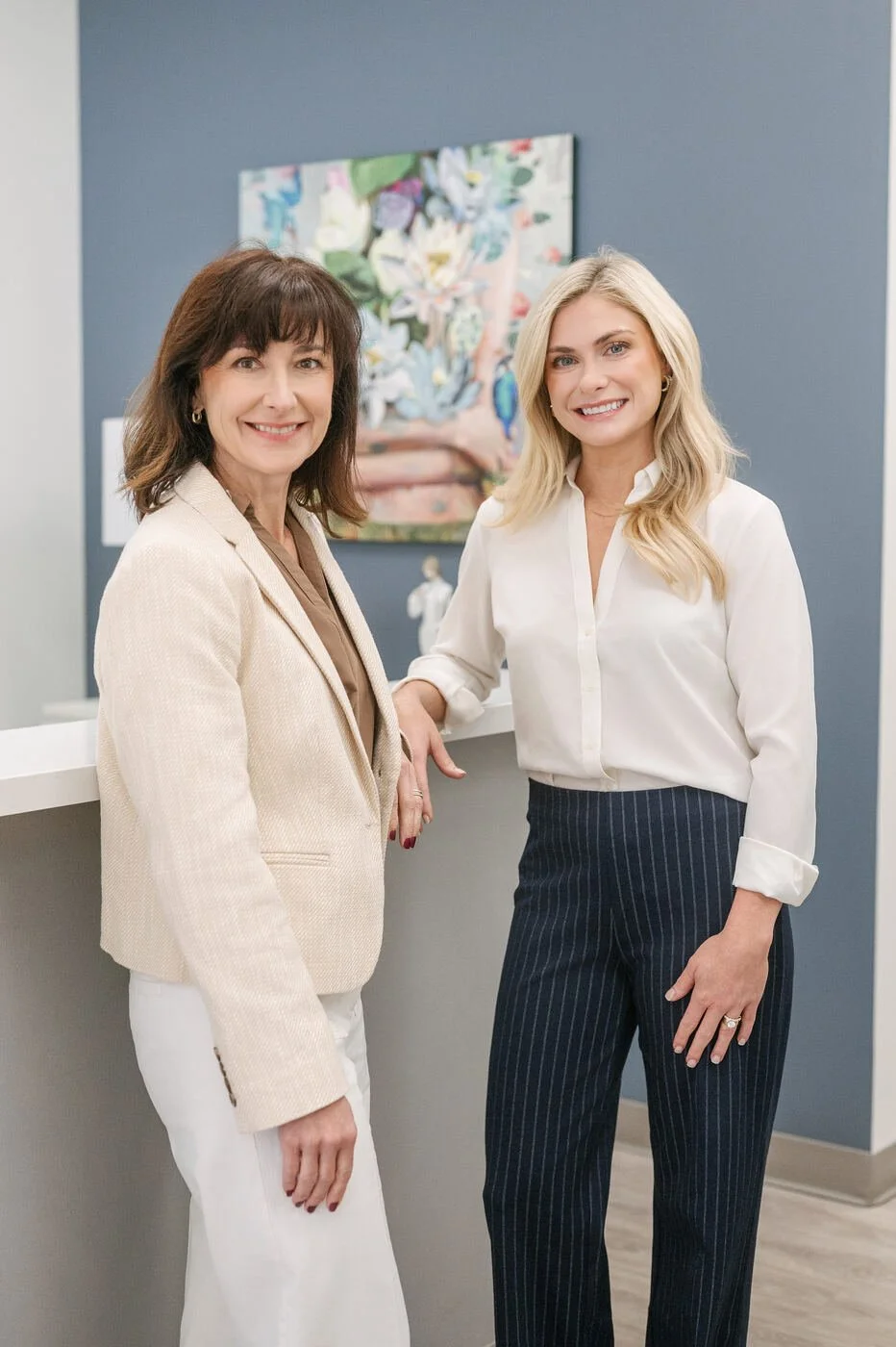 Dr. Robin Bone, MD, and Maggie Theriot, DNP, FNP-C, at the front desk of Signature Health in Metairie, LA