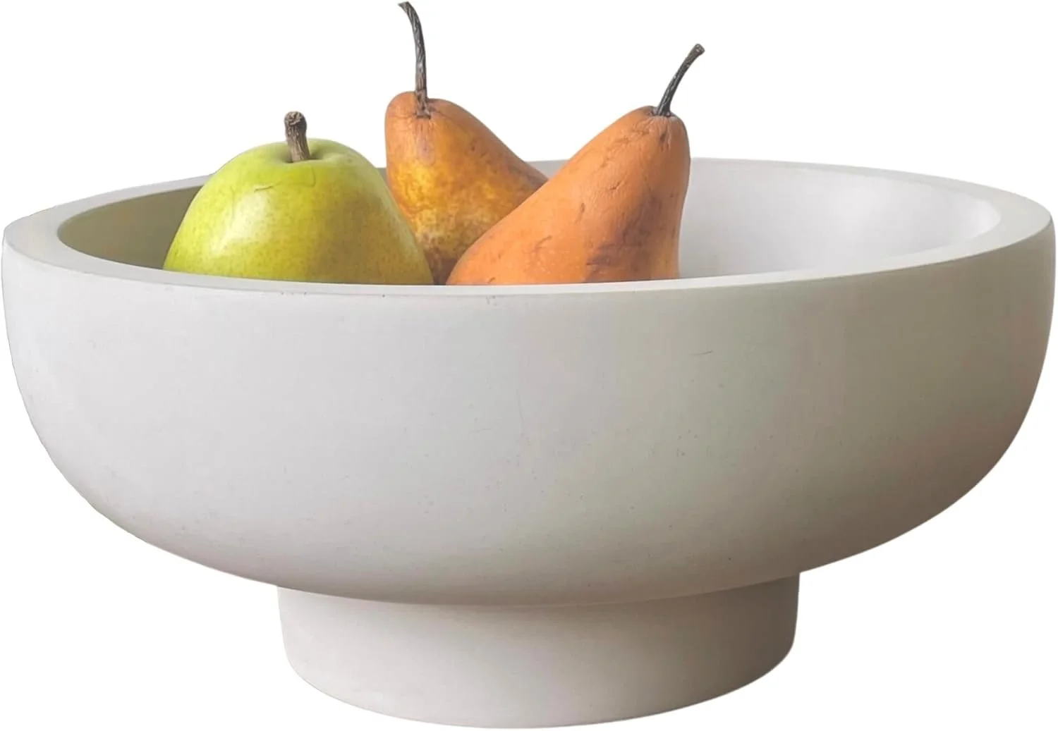 White ceramic bowl with three pears inside, one green and two brownish-orange, on a white background.