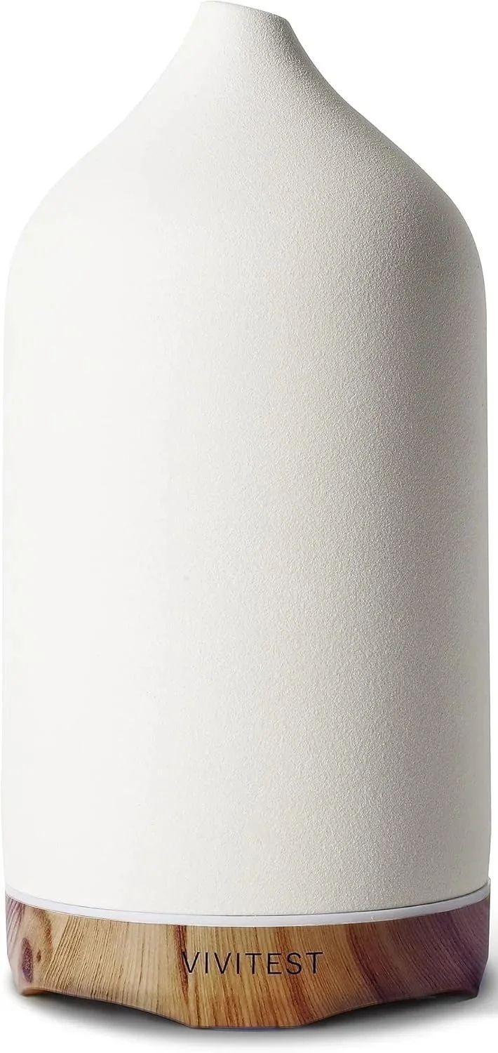 A white VIVITEST ultrasonic diffuser with a wooden base.