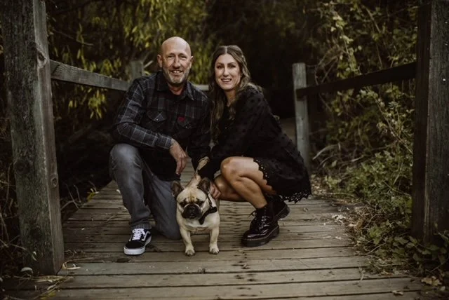 Owners of Willenborg Roofing with their French Bulldog, representing a family-owned roofing company serving North Idaho