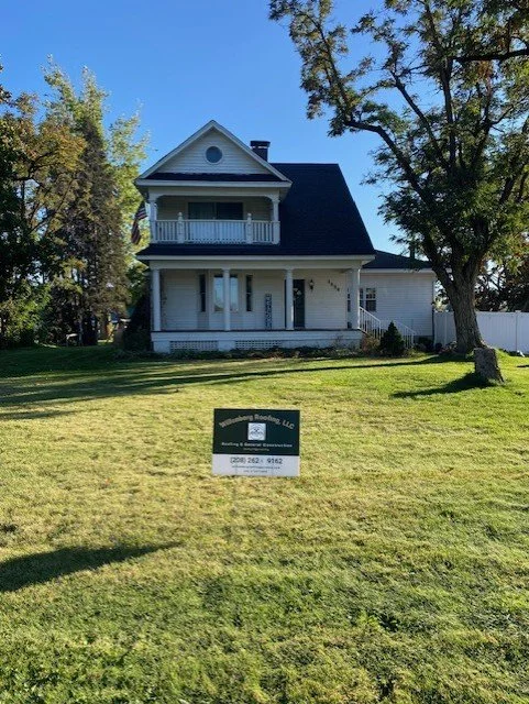 Completed residential roof replacement with yard sign by Willenborg Roofing, serving North Idaho homeowners.