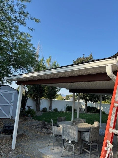 Residential asphalt shingle roofs and gutter installation in a North Idaho neighborhood, illustrating dependable roofing solutions by Willenborg Roofing.