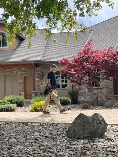 Residential roofing project by Willenborg Roofing in North Idaho, featuring a completed gray asphalt shingle roof on a brick home.