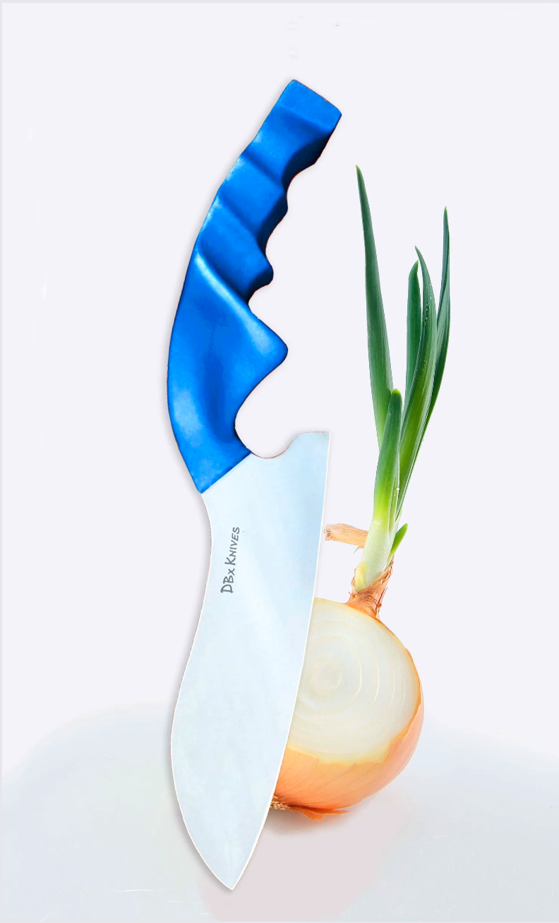 A knife embedded in a partially cut onion with green onion sprouts growing from it.