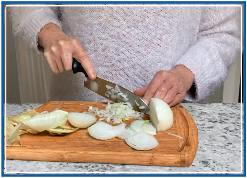 Cathy slicing onion with DBx santoku — essential tremors home cook Laurel MD