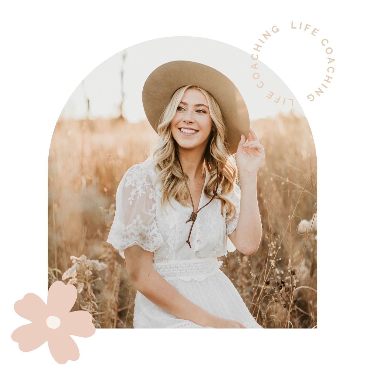 A young woman with long blonde hair smiling and wearing a wide-brimmed hat, sitting in a field of tall, dry grass.